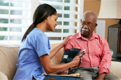 elder man having his blood pressure checked
